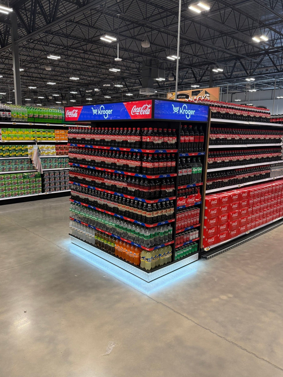 A Point of Purchase End Cap Display for Coke with bottles on the shelves and gondola shelving behind