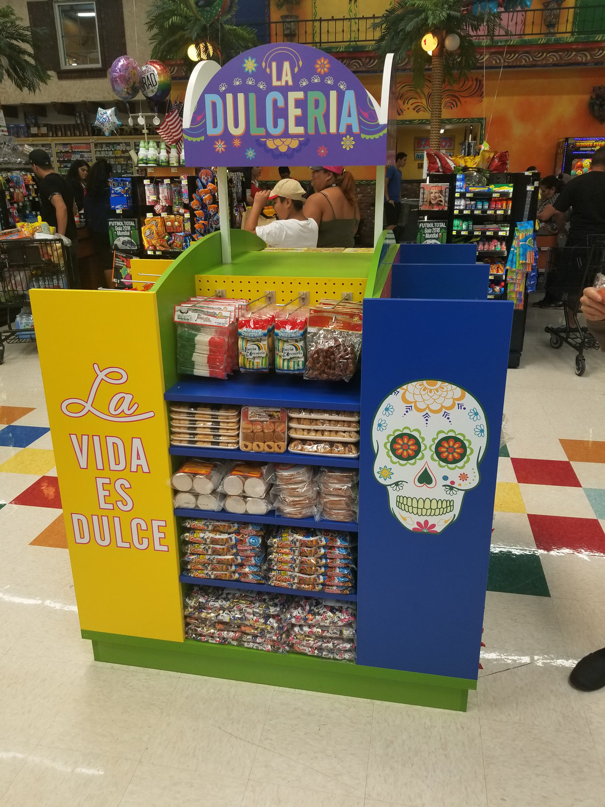 Custom display island with colorful branding and product display in a store setting