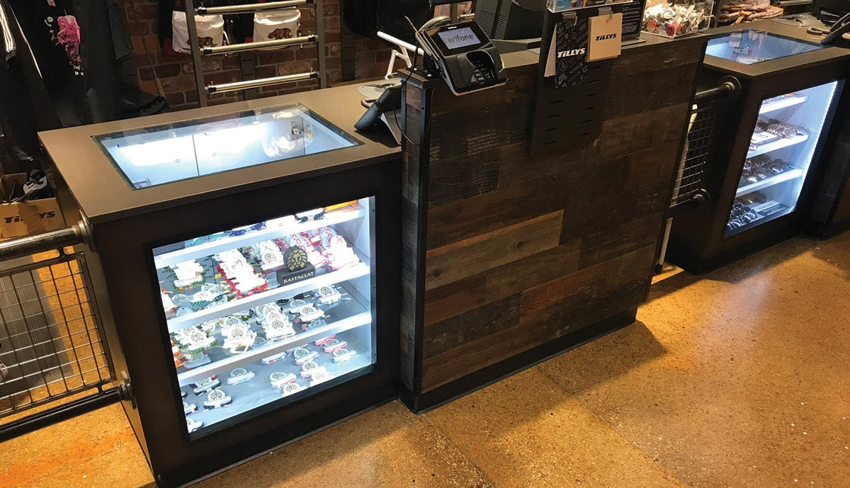 Modern retail counter with display case and cash register in a retail setting