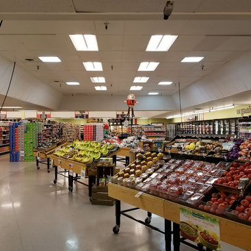 Grocery store display tables with various products 