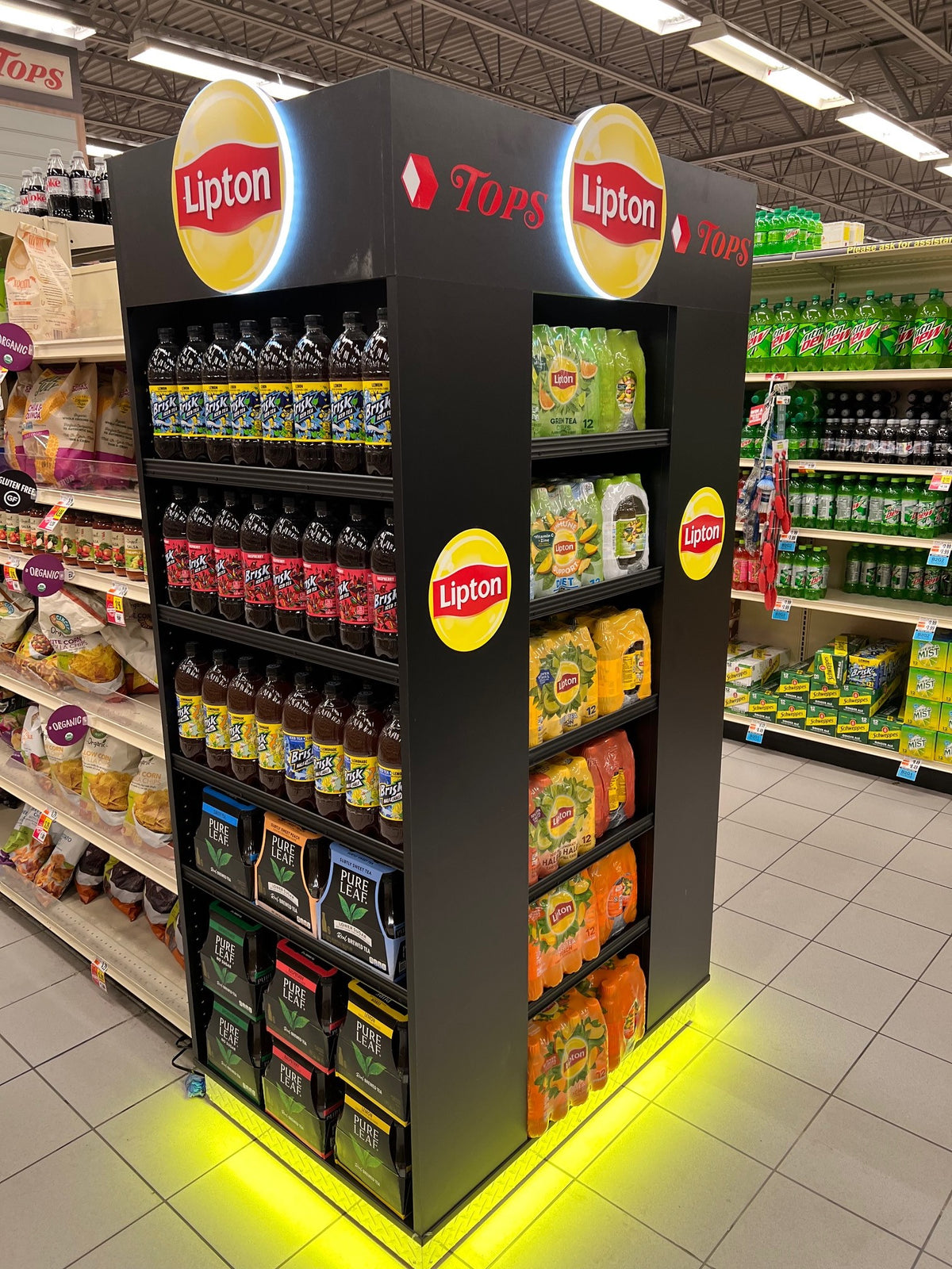 Lipton Endcap display in a grocery store with various Lipton products on shelves.