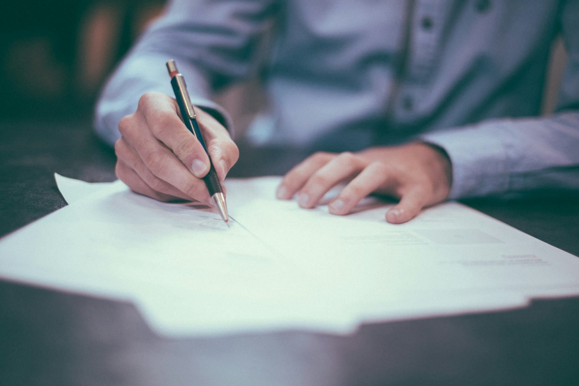 Man designing store fixture with pen on paper