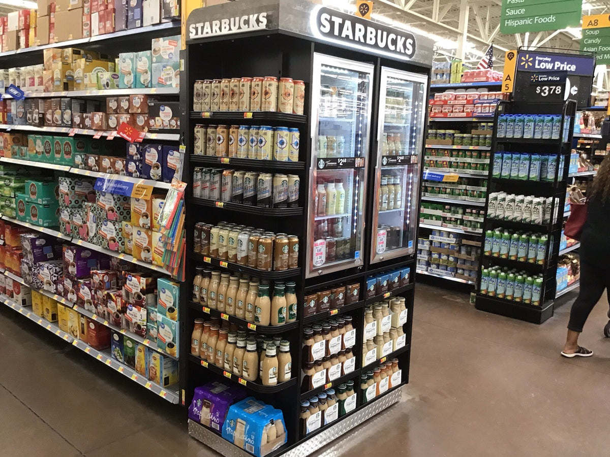 A starbucks End Cap with Cooler and product in front of Gondola shelving